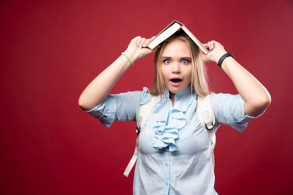 young blonde student woman holds her book her head looks tired confused 114579 77349